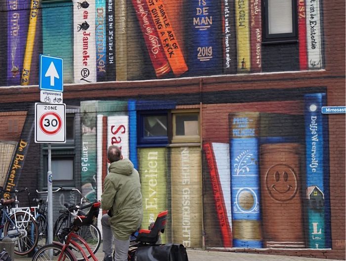Dutch Artists Paint Giant Bookcase On An Apartment Building Featuring Residents’ Favorite Books